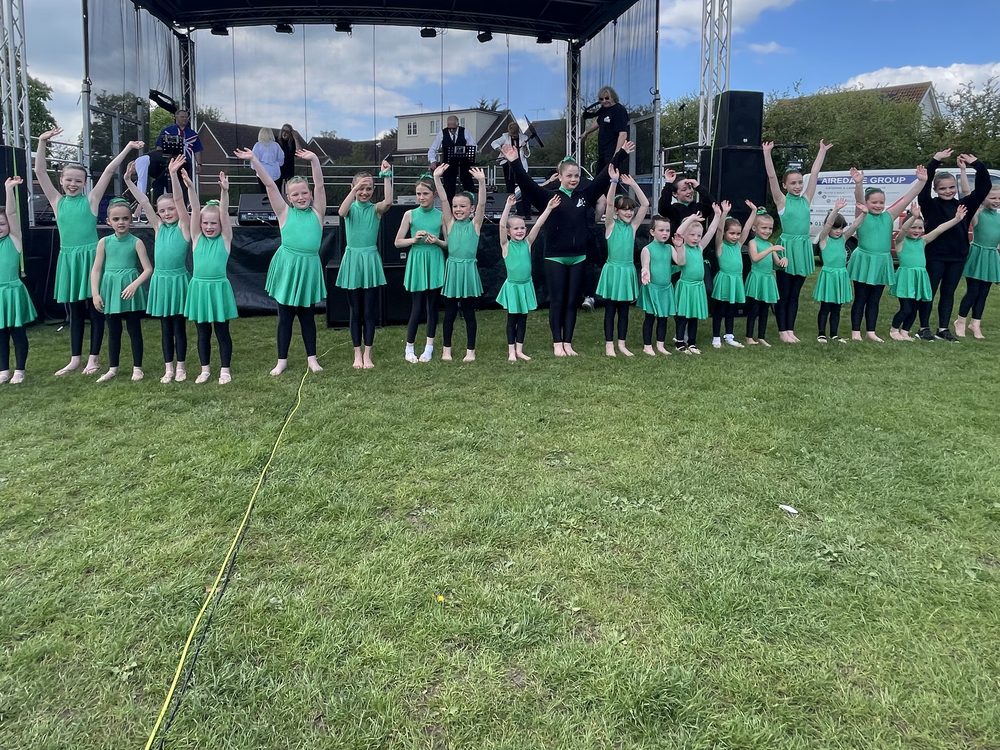 Young KADA dancers performing on an outdoor stage